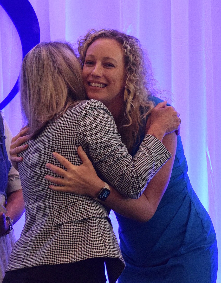 Cherri Kessler of Hancock Whitney Bank hugs Brittany Lamont, the president and CEO of the Lakewood Ranch Business Alliance, after winning the Networking Queen award.
