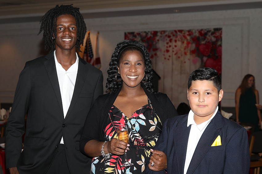 VMA graduate and about to become an ODA class of 2025 alum is Ira Jenkins, Jr., mom Fayth Jenkins and table escort, Marvin Pacheco.