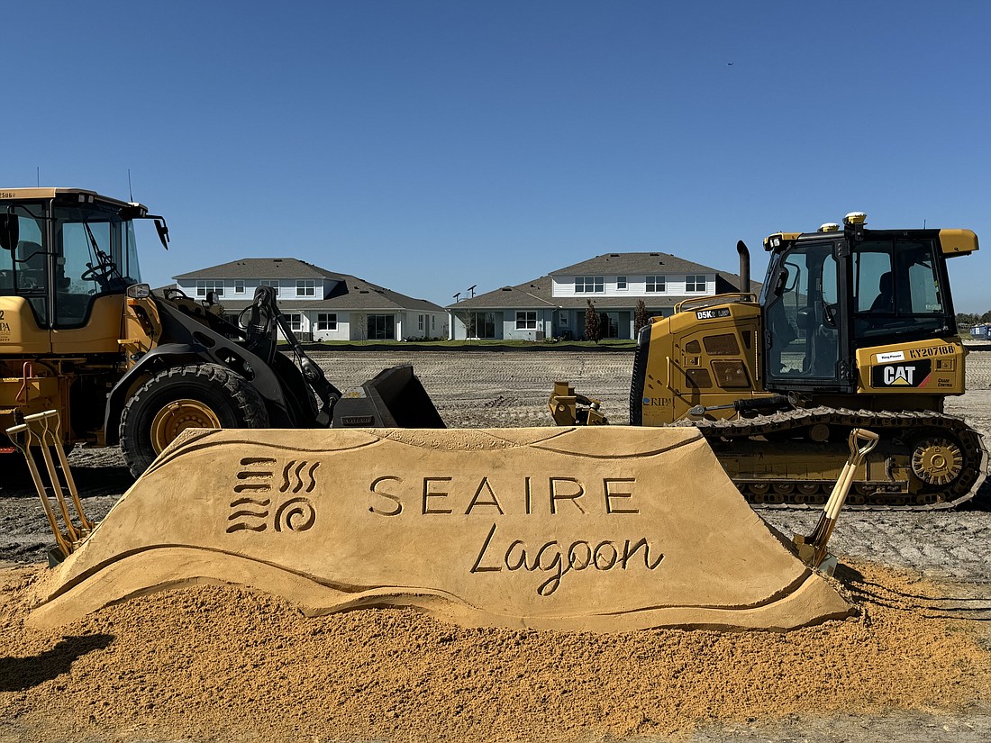 Behind the bulldozers, a 4-acre lagoon is being built as as beach-like amenity for residents and the community.