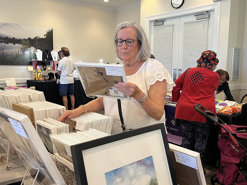 Lakewood Ranch's Carolyn Gilbert browses Lakewood Ranch's Stacey Lipton's paintings. 