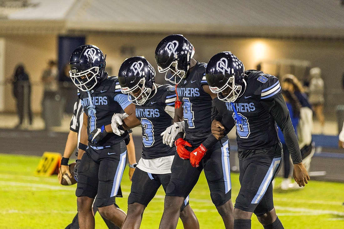 Dr. Phillips captains Maliki Wright, left, Cam Dixon, Mykel Calixte and Stanley Anderson-Lofton took the field for the coin toss.