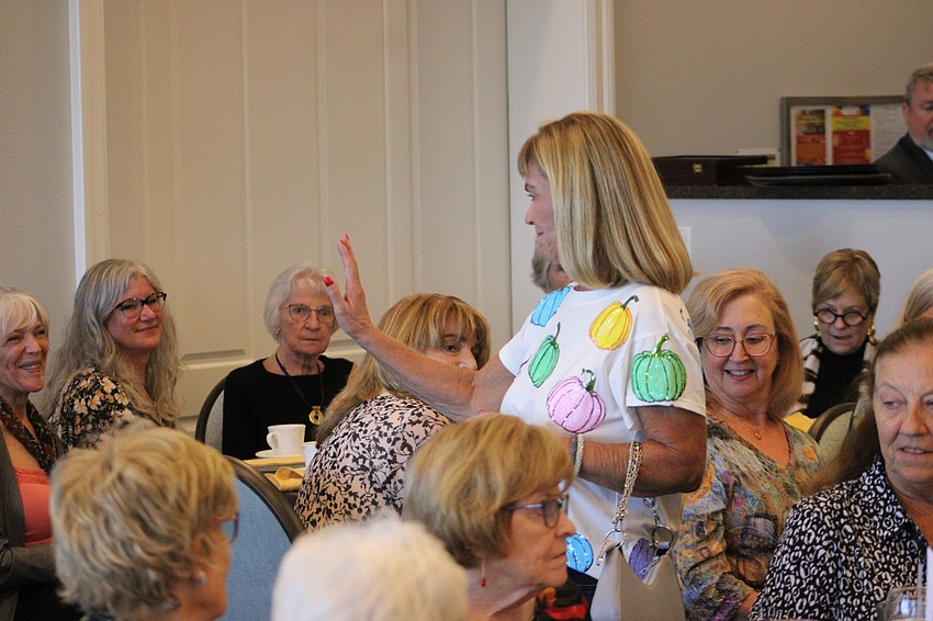 Nancy Cole makes her way through a sellout crowd for the fashion show.
