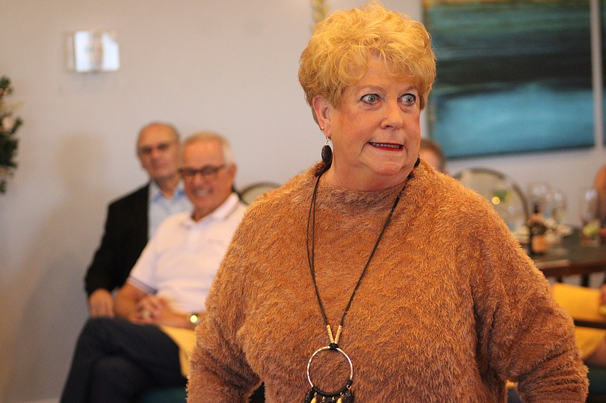 Susan Greene has a little fun with those enjoying the fashion show.