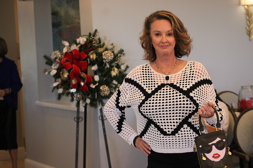 Linda Schultz shows off a rather distinctive purse during her walk down the runway.