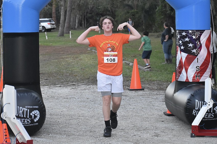 Seventh Grader Kyson Chapman crosses the finish line of the Turkey Trot, placing second in his age group.