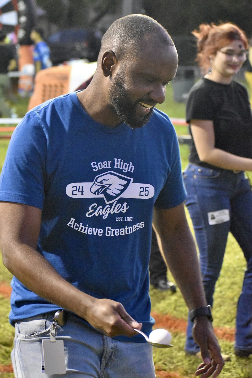 McIntosh Middle School principal McHenry Lerebours plays the Egg and Spoon Race.