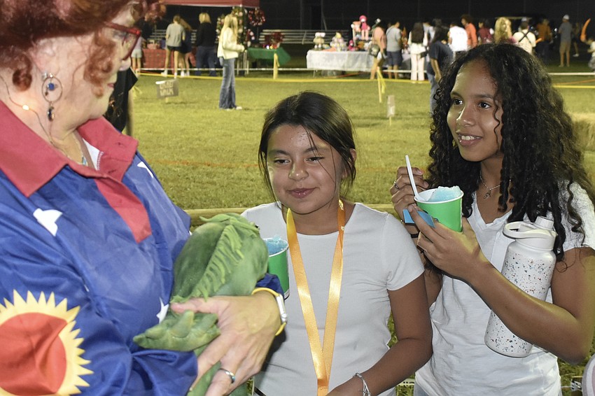 Science teacher Schelly Shaughnessy, dressed as Ms. Frizzle, talks with sixth graders Angela Martinez and Allison Hammer.