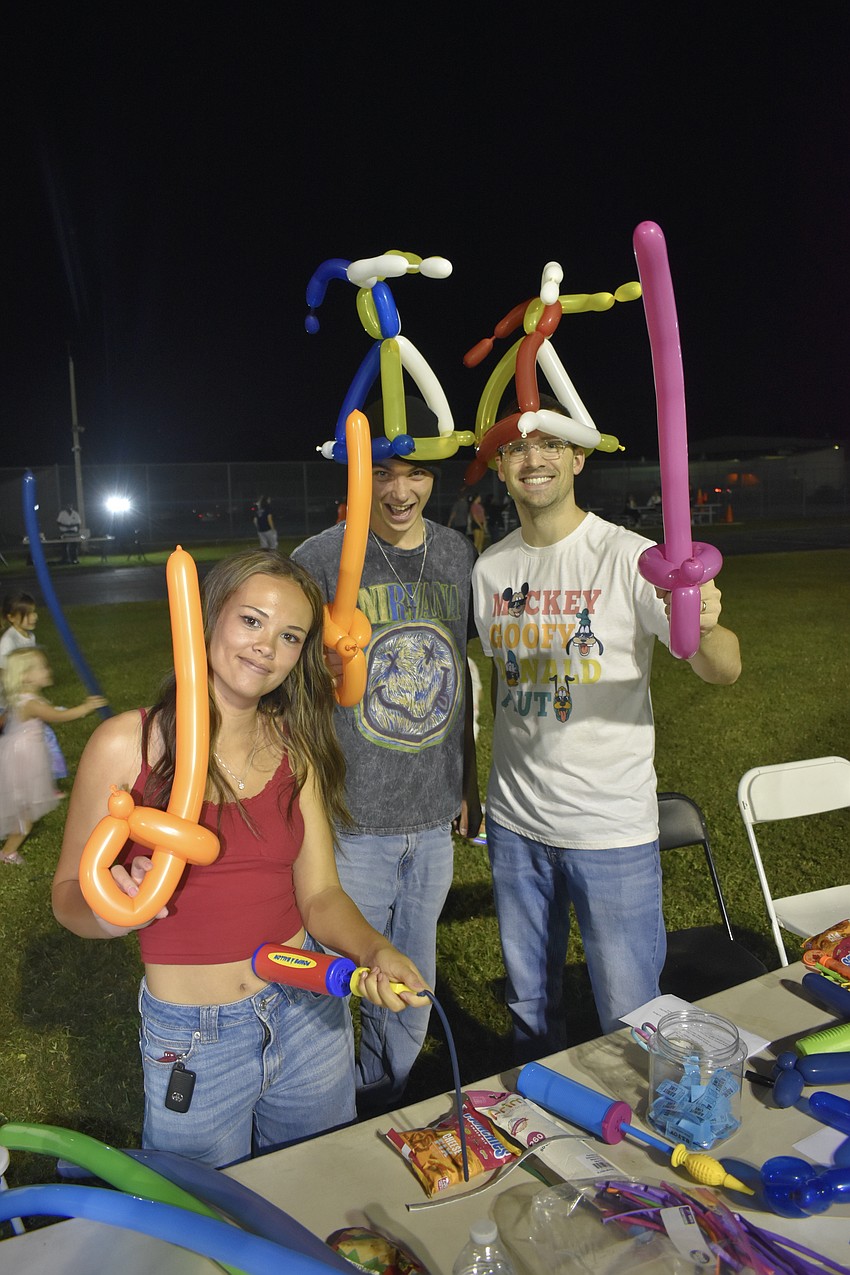 Sarasota High School juniors Alanah Lytle and Kieran Clarke, and McIntosh Middle School teacher Mark Prybylski provided balloons.
