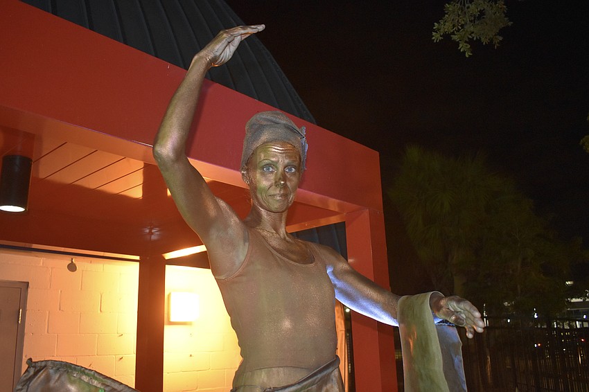 Jacque Slayton portrayed a living statue as guests entered the event.