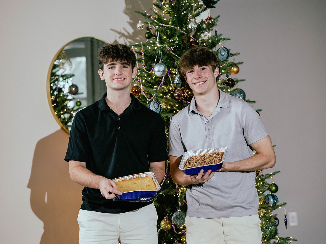 Windermere High School Student Government Association treasurer Chase Prevett, left, and Luke Malegni are excited to be able to provide home-cooked Thanksgiving dishes to families throughout the area.