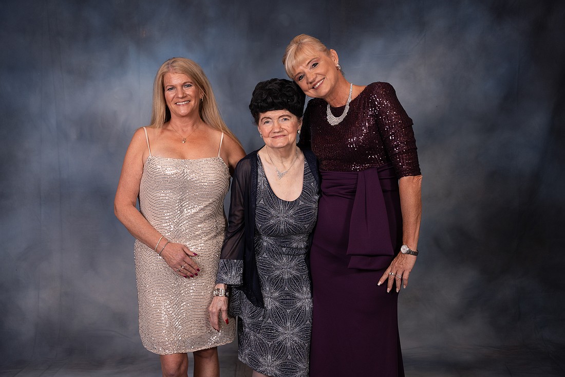 Hamlin Elementary School leader Angela Murphy-Osborne, right, is the Florida Principal of the Year. She attended the awards banquet with friend Janet Lanham, left, and mother Kathy Murphy.