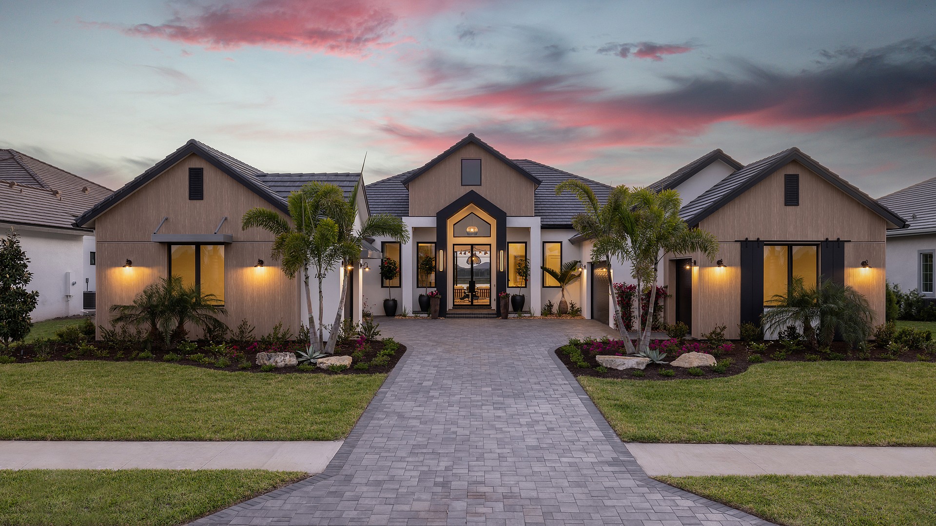 The home’s bold exterior design, classified as “farmhouse modern,” offers a mix of bold elements softened by wood accents.