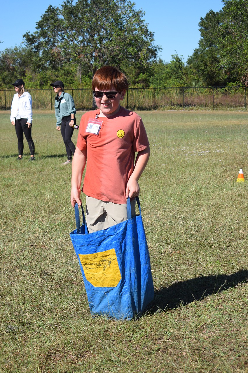 Fifth grader Isaac Nichols races to the finish line, ending in a dive. 