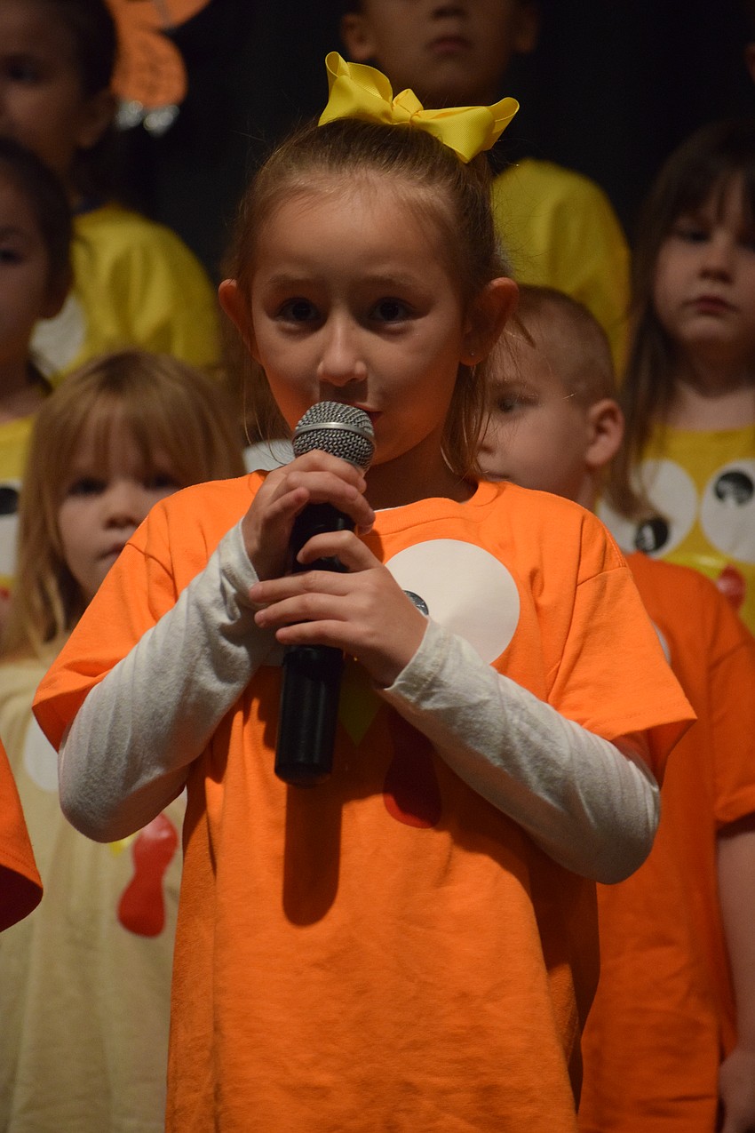 Kindergartner Callista Bravo helps to kick off the Thanksgiving program by welcoming guests.