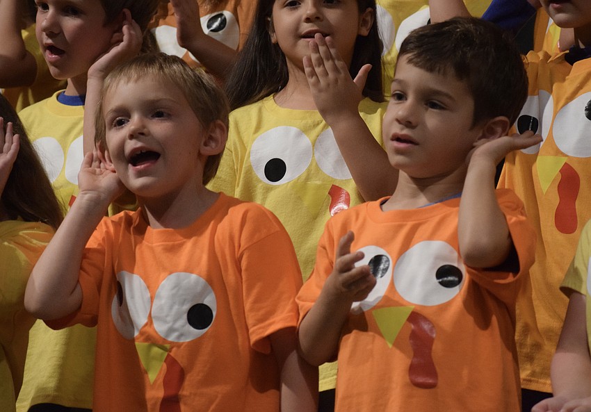Kindergartners Cohen Ruthven and Dax Morrow sing and dance to one of several songs the kindergarten class performed in its annual Thanksgiving program.