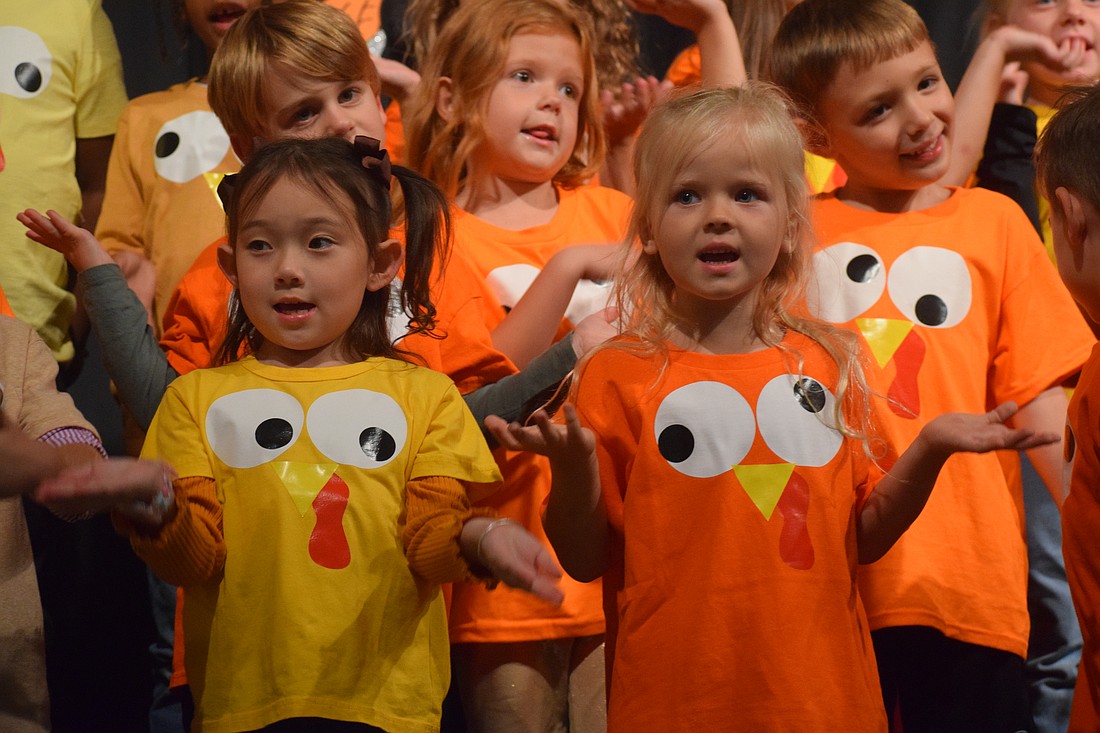 Kindergartners Mila Park and Eliana Fitzmorris give it their all in every song.