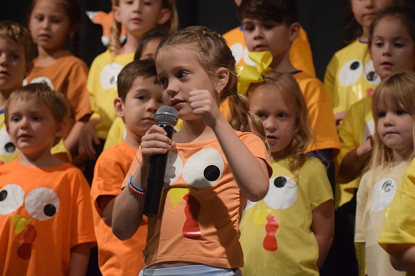 Kindergartner Jesse Plummer leads the rest of the kindergarten class in the start of their Thanksgiving poem.