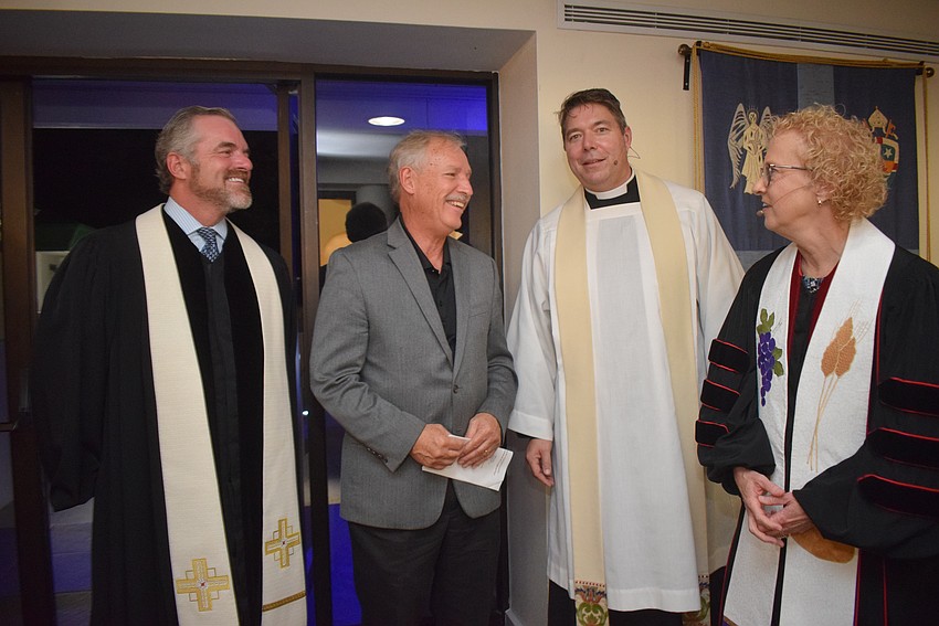 The Rev. Brock Patterson, Rev. David Marshall and Rev. Julia Piermont chat with Town Manager Howard Tipton.