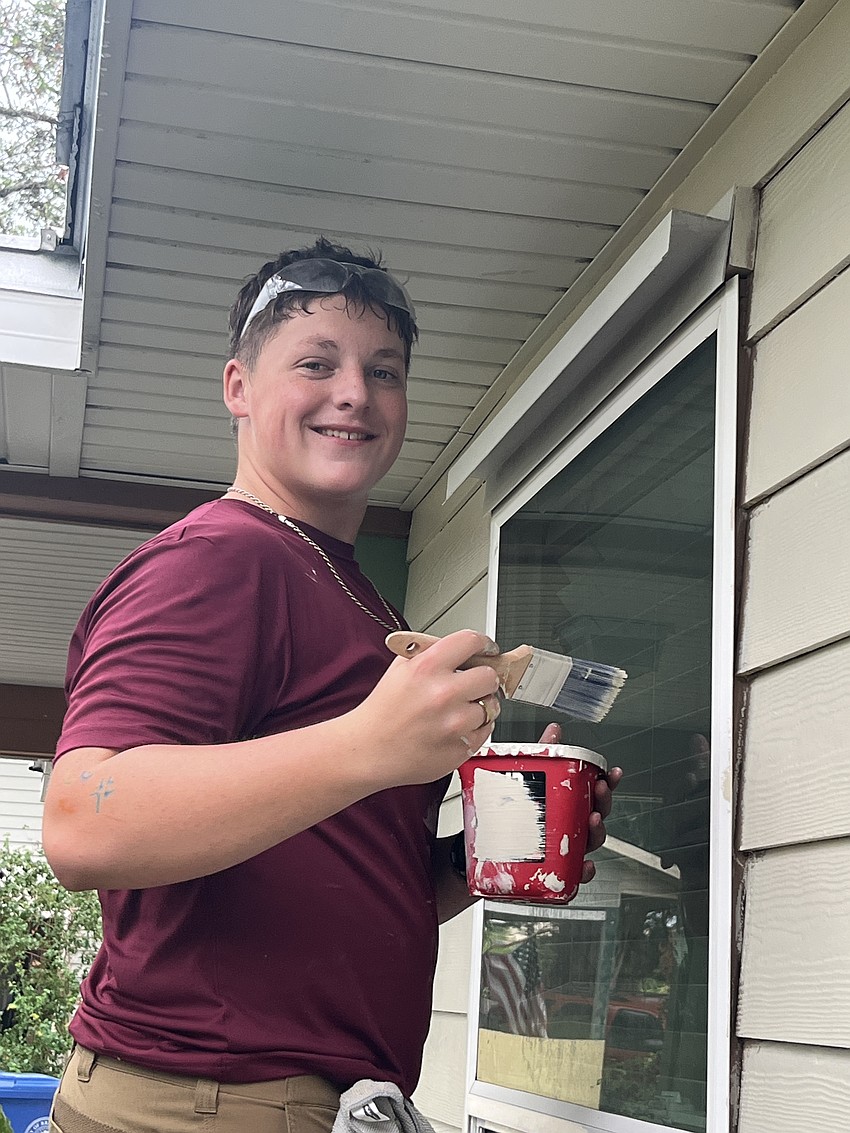 Junior Kyle Clerkin pays attention to all the details as he paints the exterior of the home.