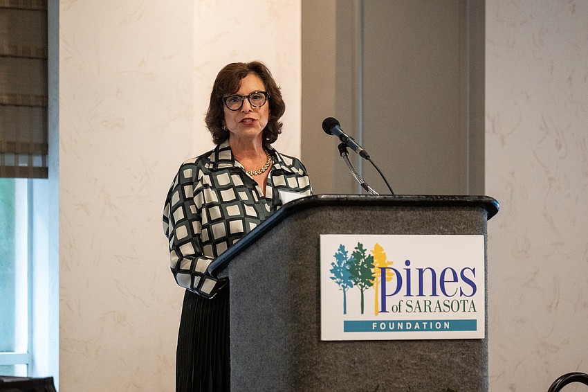 Board member Lisa Keverian-Press adresses the guests.