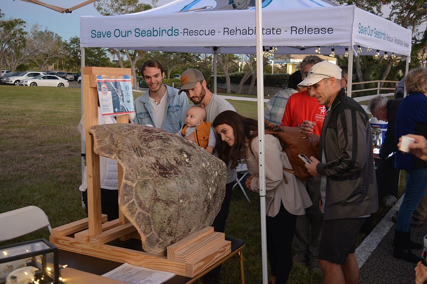 The Condensa and Carter family visits Longboat Key Turtle Watch's set up at Light Up Longboat.