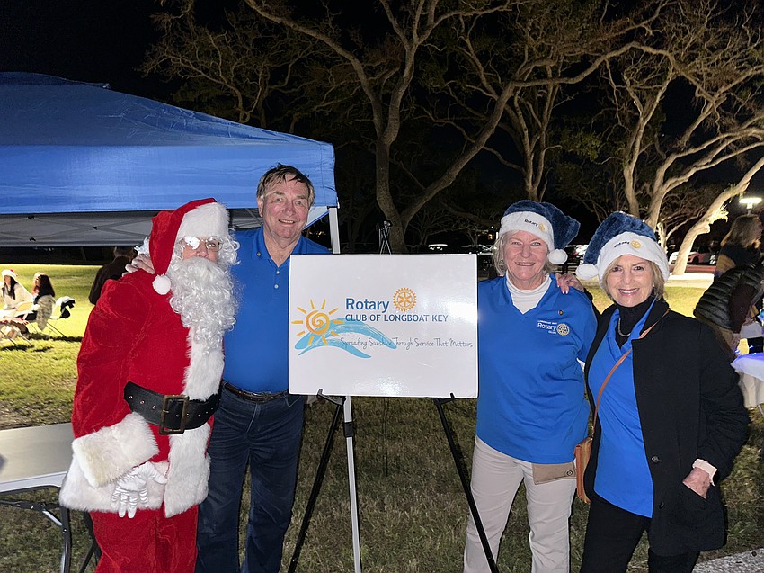 Nancy Rozance (Santa), Jack Rozance, Carol Erker and Jan Wallace with the Rotary Club of Longboat Key.
