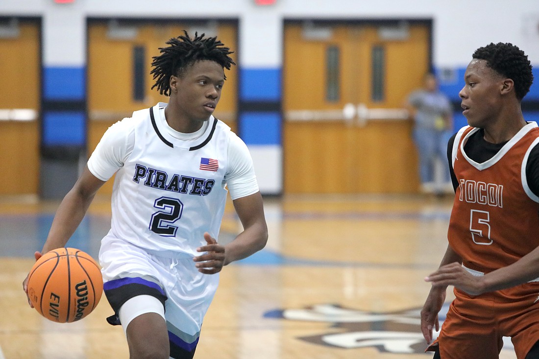 Matanzas junior Nathaniel Perry (2) is guarded by Tocoi Creek's Javares Rickerson. Photo by Brent Woronoff