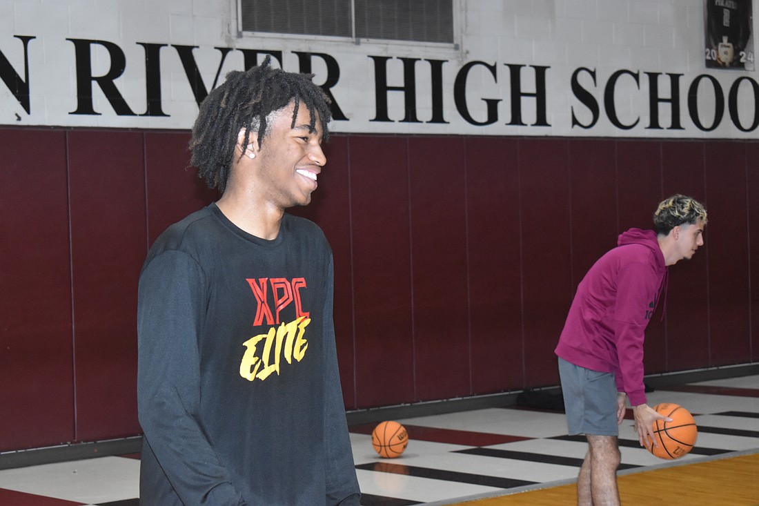 Braden River sophomore guard Jerrod Long (front) has a laugh during practice with junior forward Sebastian Rivera.