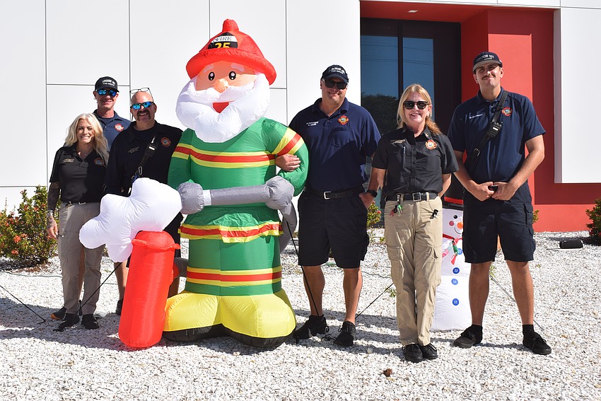 Tara Pavgouzas, Denny Bickel, Brandon Desch, Brent Kruse, Jane Herrin and Chris O'Brien from the Longboat Key Fire Rescue enjoying the Holiday decorations.