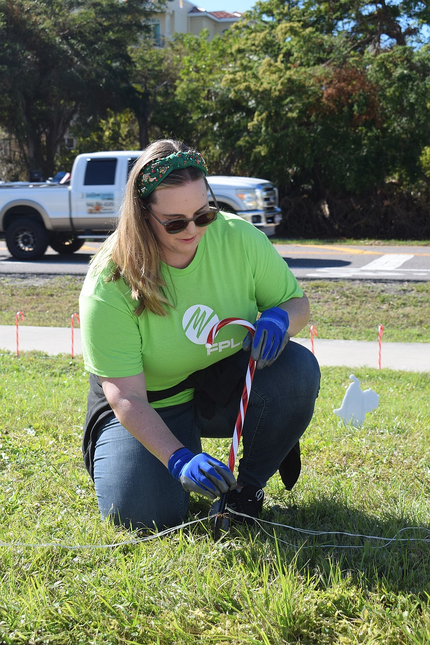 Devaney Iglesias decorating the Longboat Key Fire Station with light candy canes.