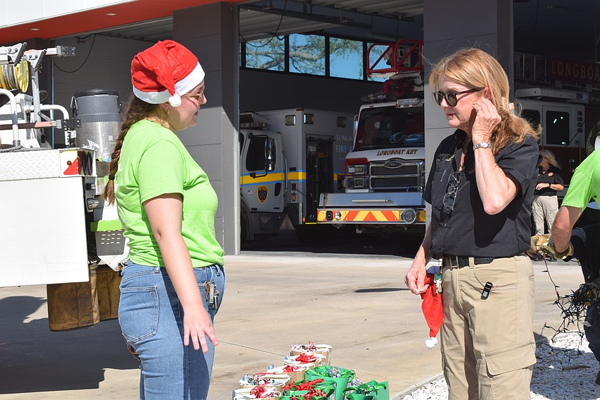 Katie Kiselewski chatting with Assistant Chief Jane Herrin about the FPL gift bags.