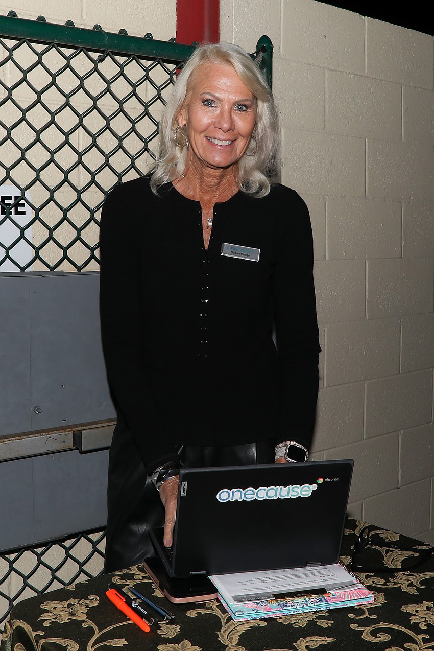 Susan Chase helps register guests.