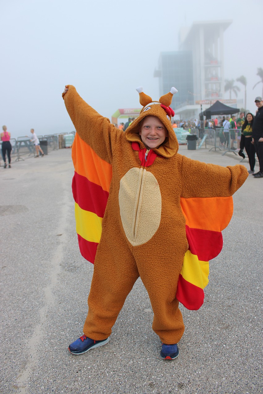 Elise Alsman, 11, visiting from Illinois, donned a turkey suit for the Florida Turkey Trot.