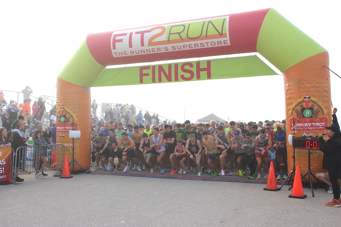 The runners all reach for their watches as the 2024 Florida Turkey Trot begins at Nathan Benderson Park.