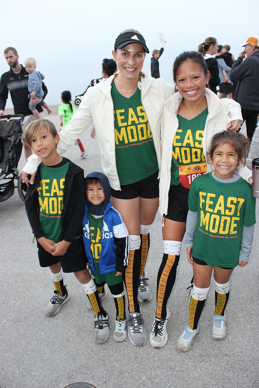 Lakewood Ranch's Hans Bhullar, 7, Obie Bhullar, 3, Lauren Bhullar, Kat Chandra, and Sophie Bhullar, 5, all prepare to run the Turkey Trot.