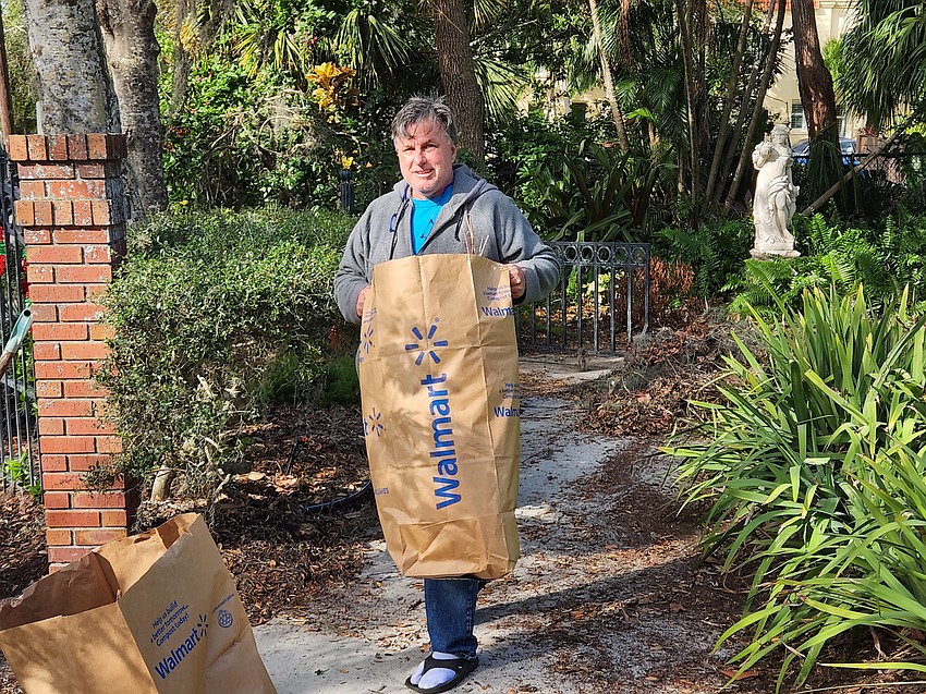 Chris Haywood hauls one of the many debris bags at Laurel Park.
