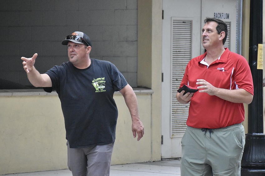 Jason Chupp, and Steve Arsenault, owner of SoCo Club Sport, which provided the cornhole games, play a round of cornhole.