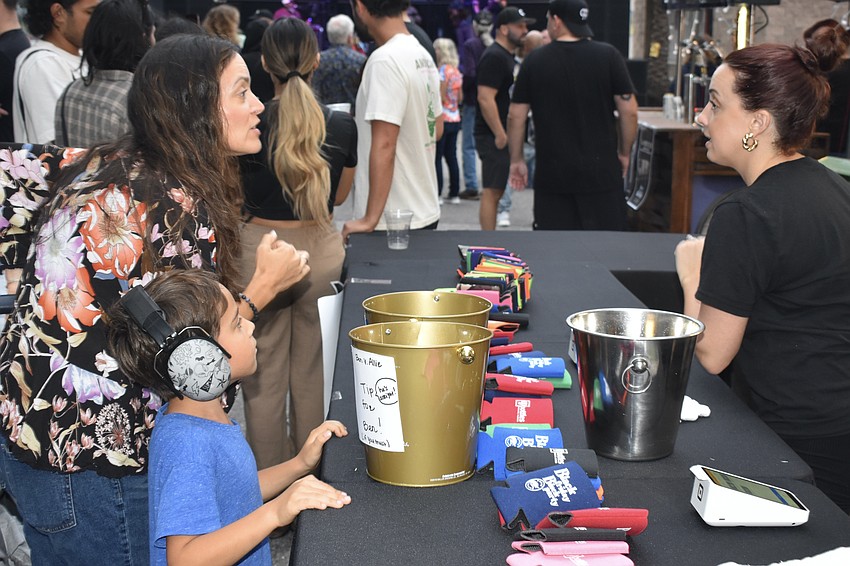 Christina Olson and Ryder Olson, 5, visit Allie Walbrown at the counter.