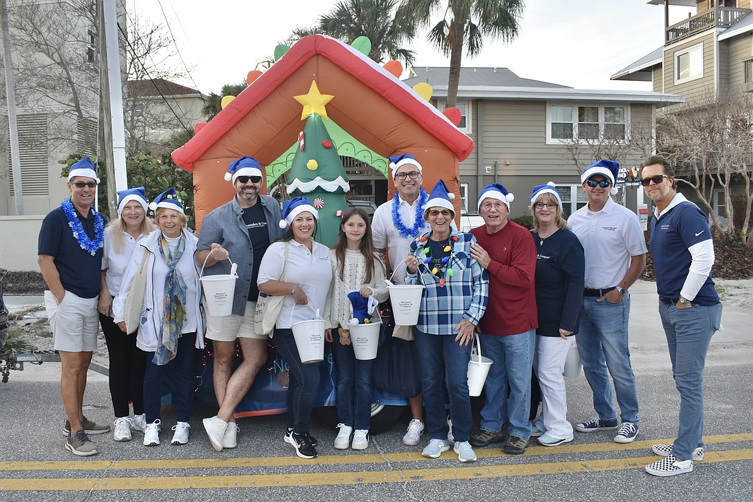 Staff from Michael Saunders & Company gather at their float.