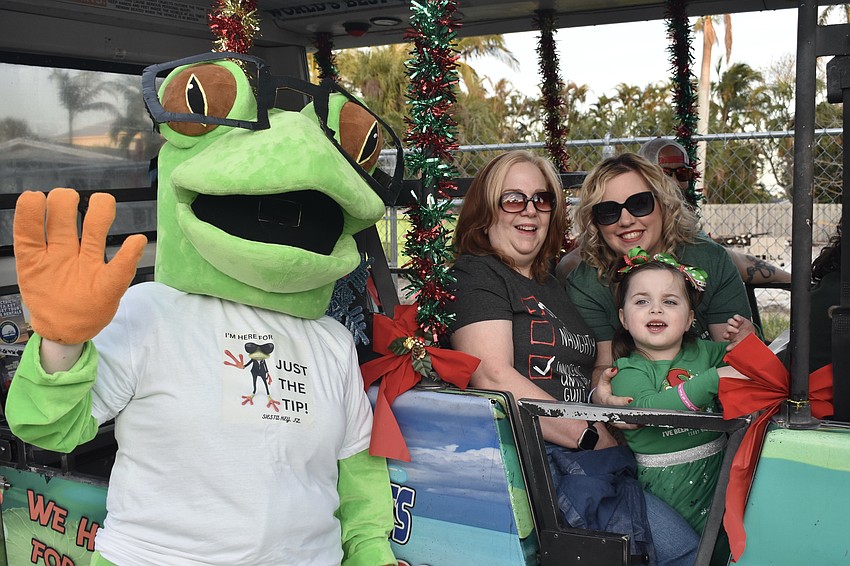 Megan Roach, Cassandra Roach and Brittaney Cadmus, and Brittaney's daughter Mia Bella Cadmus, 4 helped represent The Frog Hop trolley service.