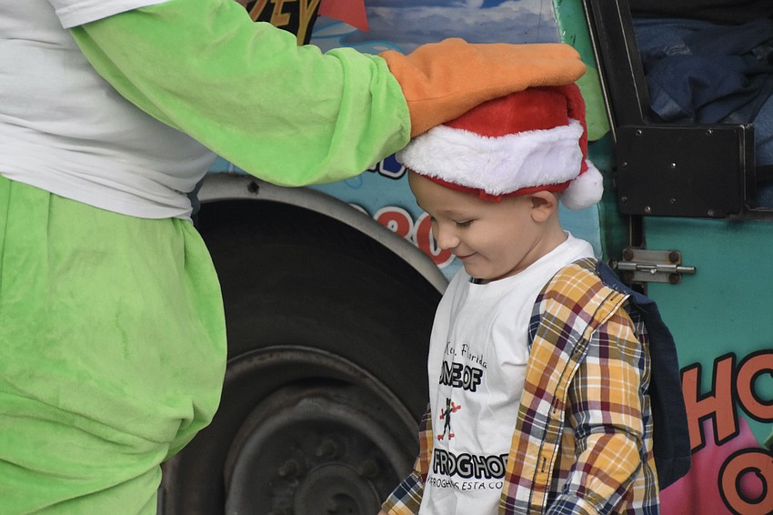 Megan Roach gives Remington Kanter, 2, a pat on the head.