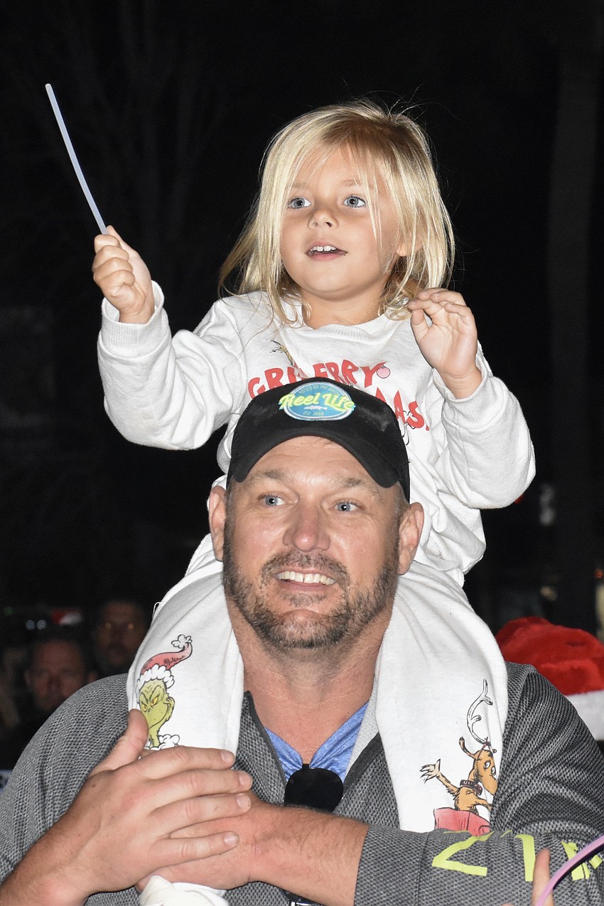 Dean DuBois and Harley DuBois, 4, watch as Santa Claus approaches.