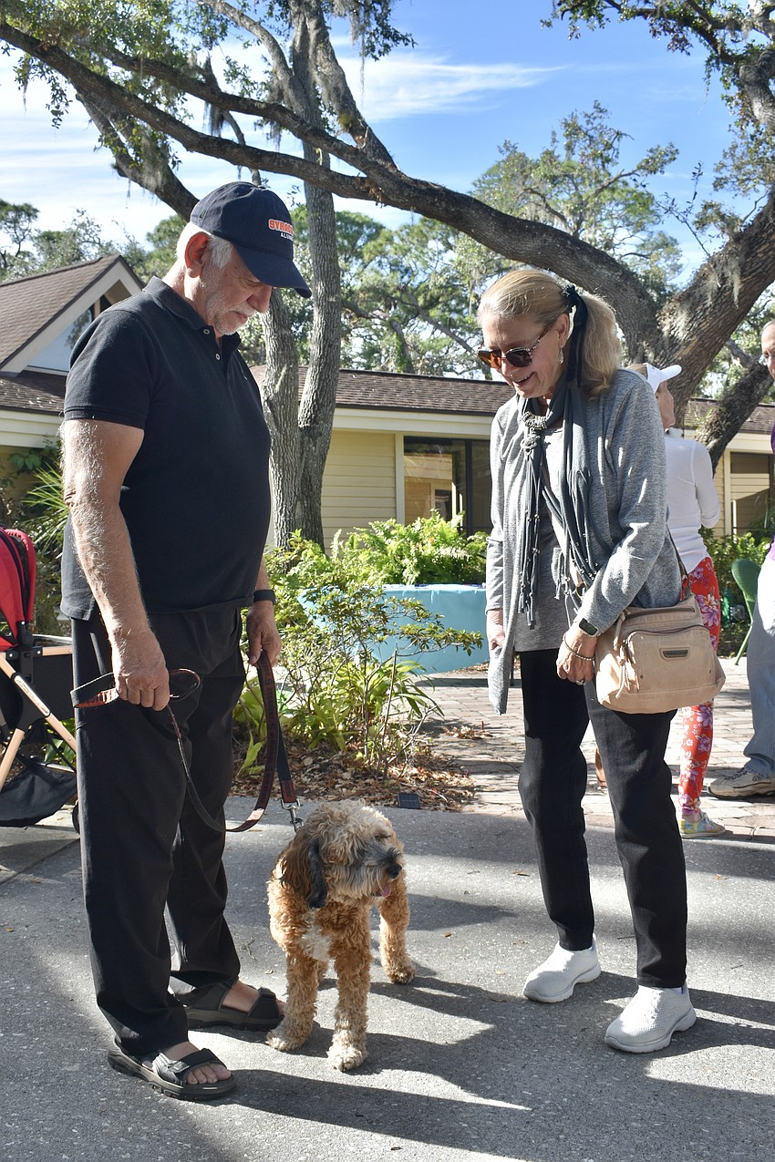 David Lewis and his dog Quincy meet with Debra Sandberg, past board president of Unity.
