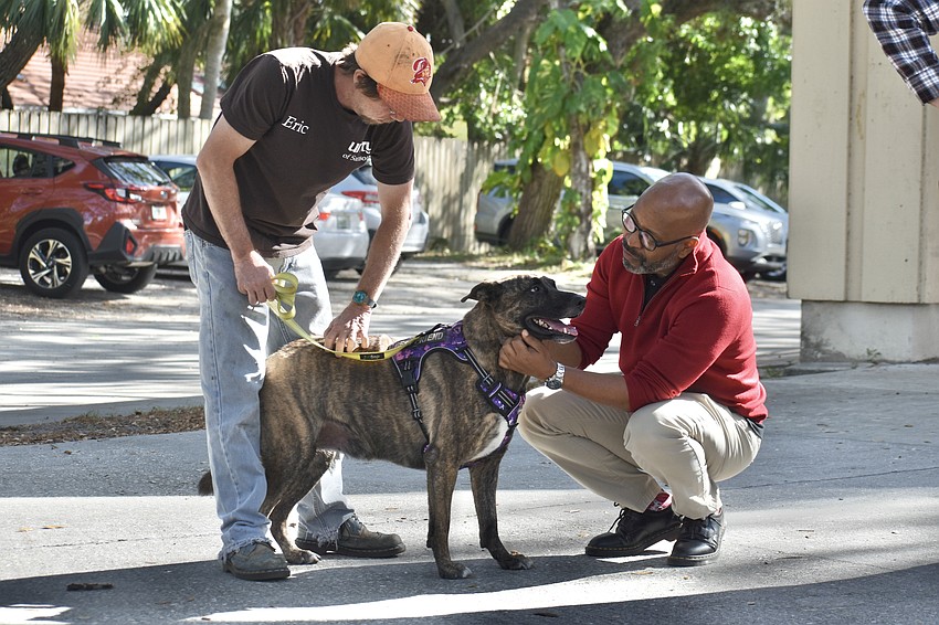Eric Wohlgamuth, maintenance manager at  Unity, has his dog Sammy blessed by Prayer Chaplain Stephen Butler.