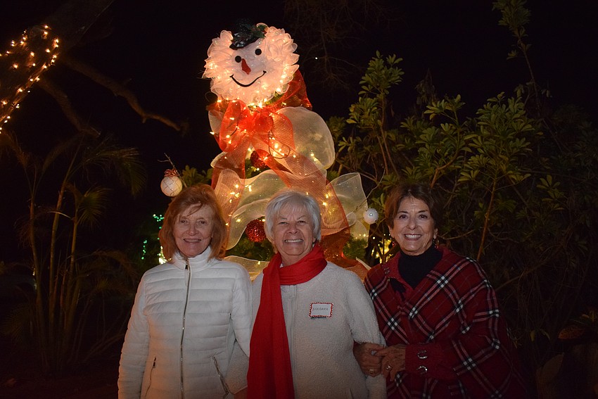 Becky Jones, Barbara Koetsier and Lesley Rife with the snowman tree decorated by Rife's daughter.