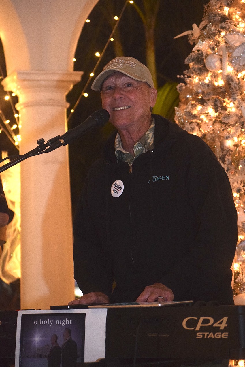 Steve Quinn from Island Breeze performed upbeat holiday songs at the first night of Christmas in the Garden.
