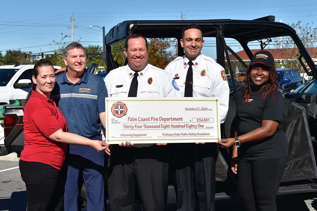 Staff from Firehouse Subs, 5615 E. State Road 100 in Palm Coast, with Palm Coast Fire Department Chief Kyle Berryhill and St. Augustine Fire Department Chief Carlos Aviles. Courtesy photo