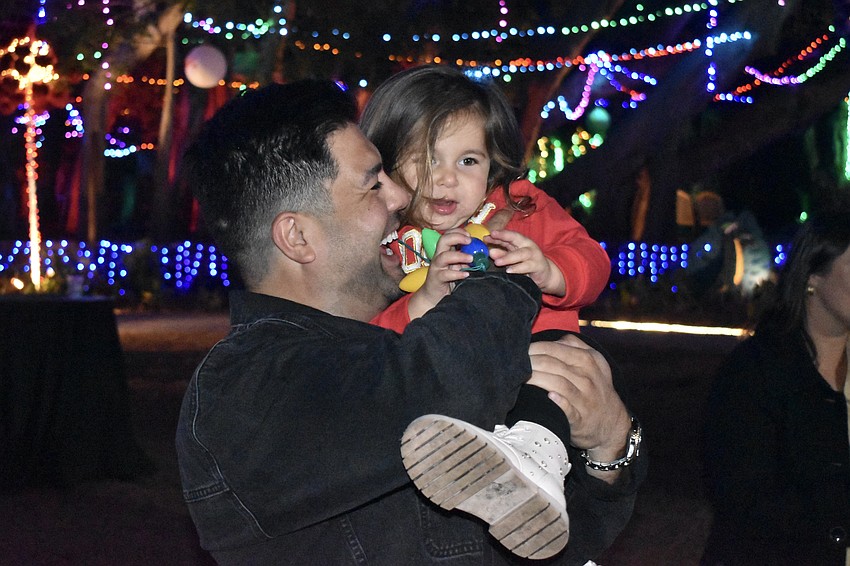 Shak Teymuri and his daughter Celine Teymuri, 2, enjoy the festive scene.
