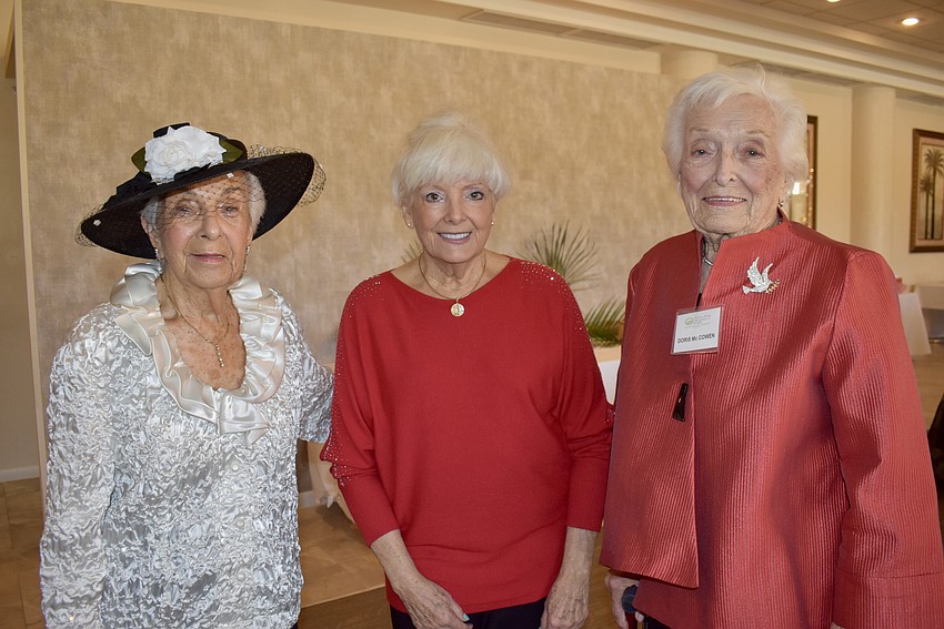 Past historian Be-Be Hansen, guest Linn Flower Evans and past president Doris McCowen head to the buffet before a performance by the State College of Florida Chamber Choir.