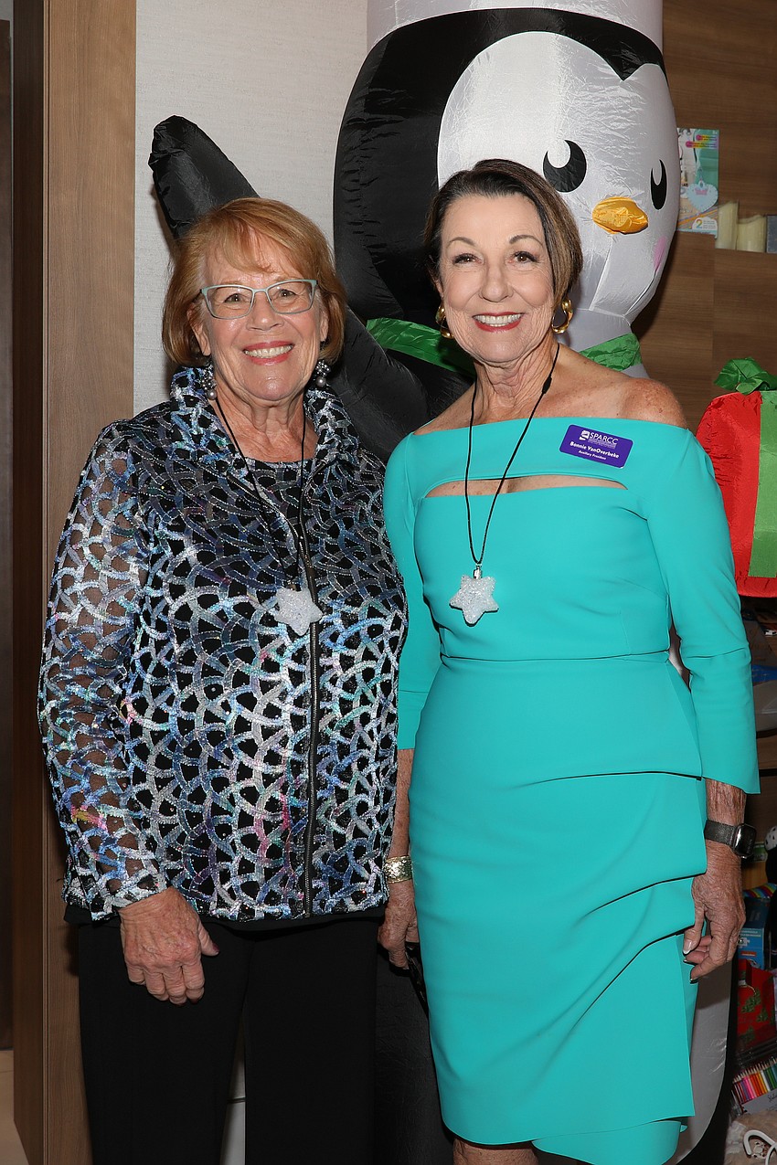 Sandy Fulkerson and Bonnie Overbeke greet guests at the SPARCC Holiday Luncheon.